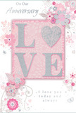 This tender anniversary card is a gentle celebration of enduring romance, the sort of keepsake you might pair with pastel-toned flowers delivered to a home off Earl's Court Road. At its centre, the word LOVE stands out in soft, raised glitter, the letters glowing in muted blush and pearly white. The letter shapes are smooth yet textured, with a shimmering silver finish that adds depth without overwhelming the design, much like a subtle metallic ribbon woven through an elegant bouquet. The O is transformed into a gleaming heart, rendered in silver with a slightly more pronounced texture, making it the emotional focal point of the card. Around this, delicate flowers in blush pink, mauve, and ivory seem to unfurl in gentle, watercolour-like washes. Their fine, flowing outlines suggest both softness and care, echoing the precise touch of a florist arranging anniversary stems for couples across Earl's Court. Curving stems, airy vines, and scattered leaves create a sense of graceful motion, as though a light breeze is softly passing through a spring garden near Philbeach Gardens. Tiny details-small petals, subtle butterflies, and scrolling flourishes-add a whisper of whimsy without disturbing the card's calm mood. The inscriptions On Our Anniversary and I love you today and always, or similarly worded messages, appear in an understated, flowing script. These lines of text sit comfortably within the design, their curves mirroring the movement of the flowers and vines. Overall, the card conveys a feeling of treasured intimacy: a quiet, heartfelt way to honour another year together, perfectly suited to accompany a romantically styled bouquet arriving at a beloved doorstep in Earl's Court.